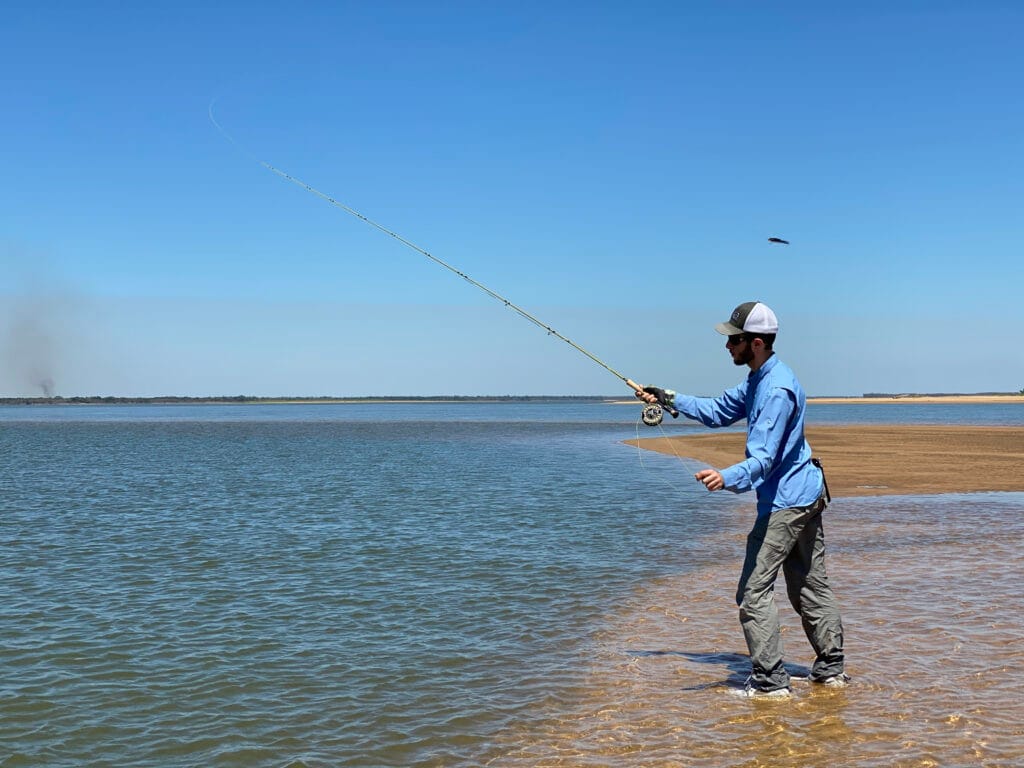 a man fishing on the beach