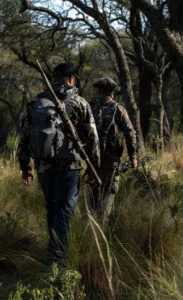 two men walking in the woods