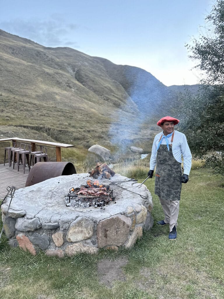 a man standing next to a fire pit