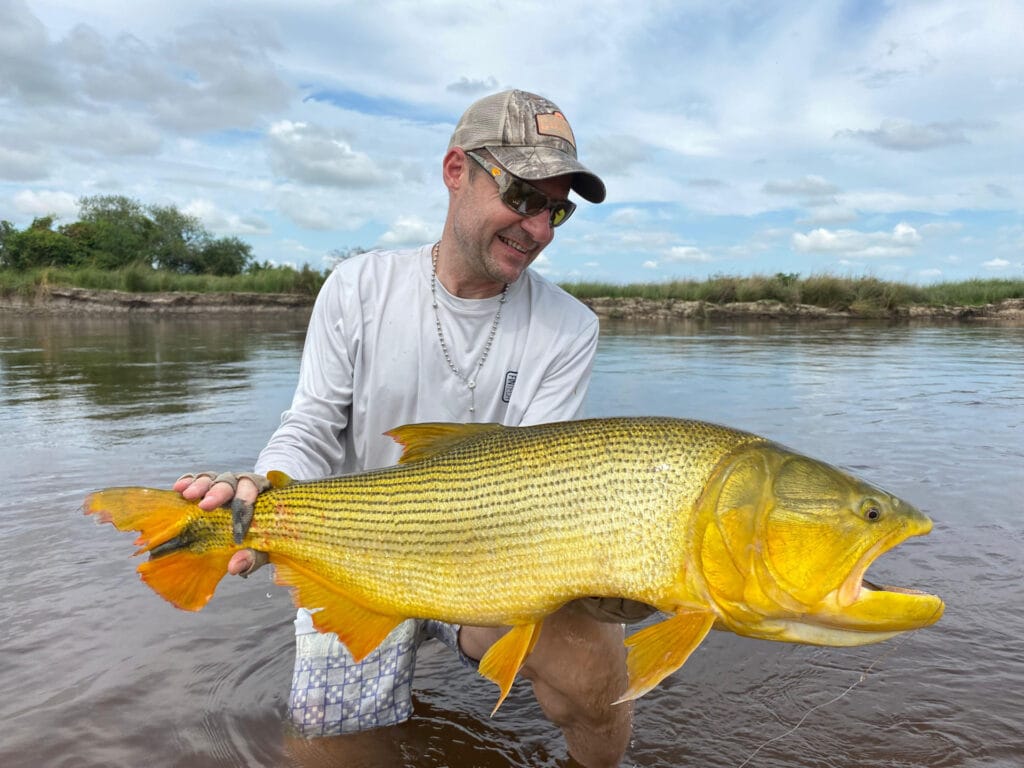 a man holding a large fish in the water