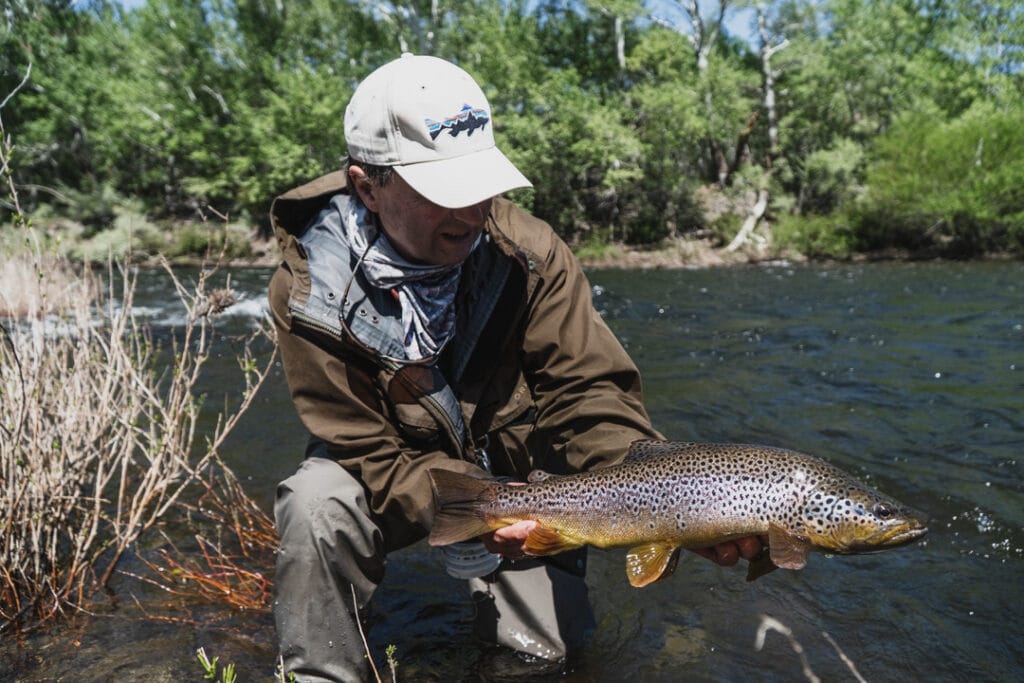a man holding a fish in the water